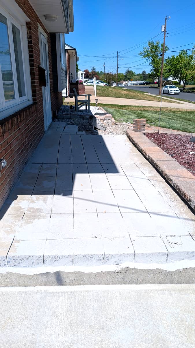 Before: old cracked concrete stoop demolished, pavers staged to rebuild the entry