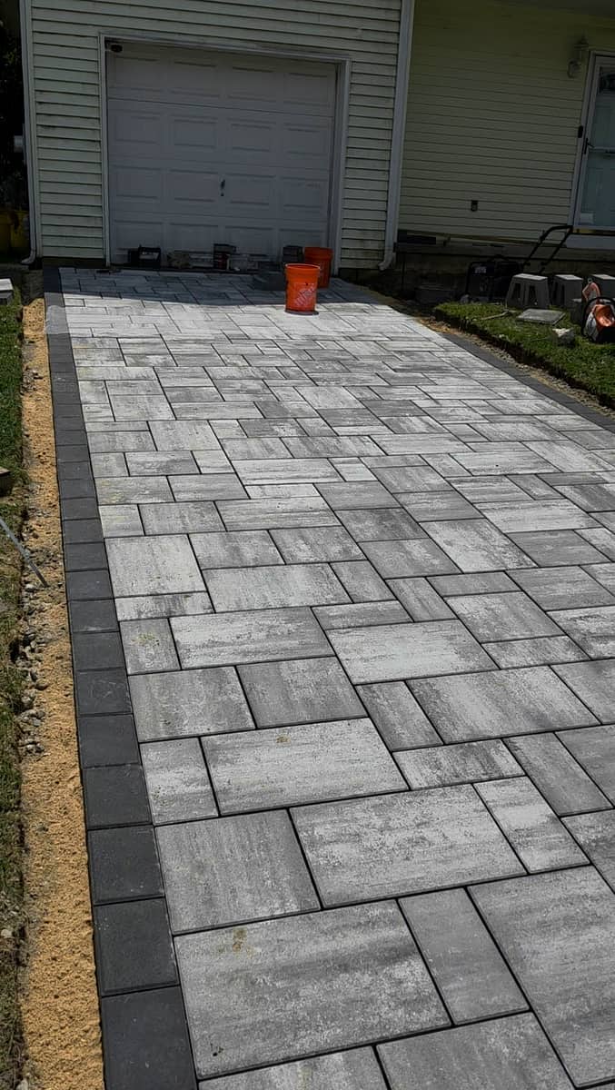 Slate-tone paver driveway with dark border