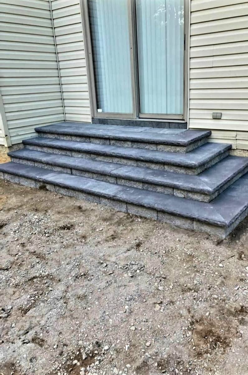 New charcoal paver steps at a back door