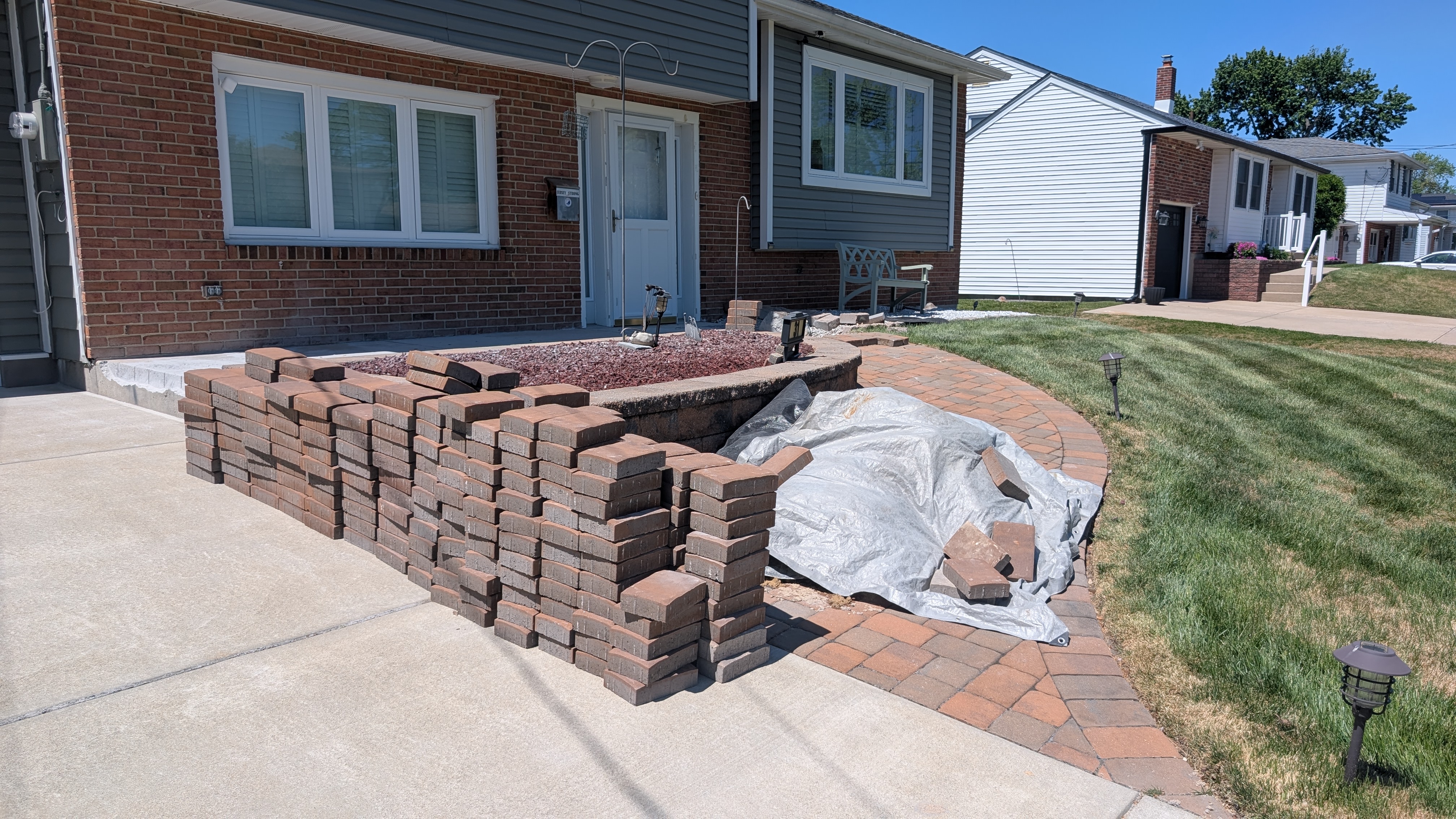 Curved paver walkway and raised paver planter bed at a Turnersville home